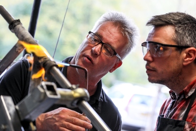 People building a bicycle