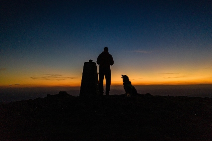 Man and his dog with the Wrekin sunrise